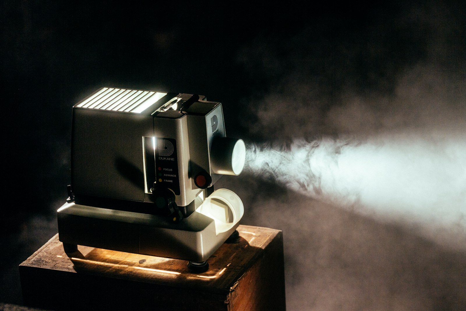 A vintage projector beaming into a dark room