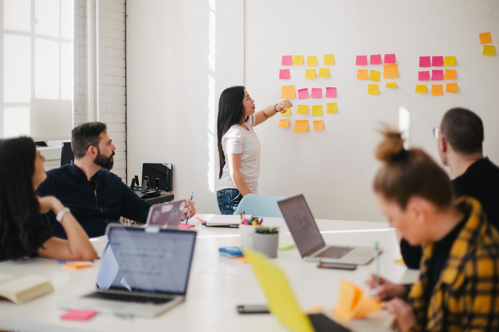 A team working around a table with a whiteboard
